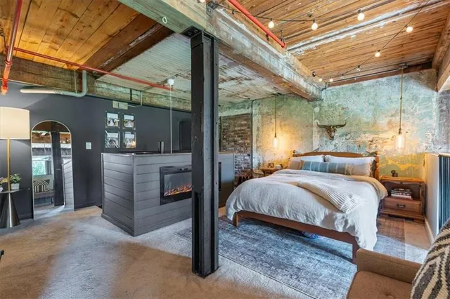 a bedroom with a bed and a fireplace