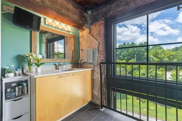 a utility room with lots of clutter and cabinets
