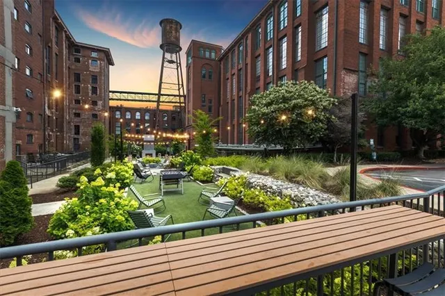 a view of a balcony with wooden benches