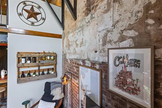 a view of a hallway with workspace and wooden floor