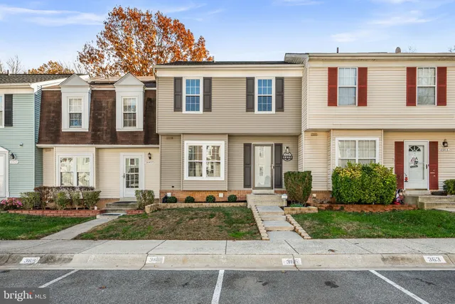front view of a brick house with a yard