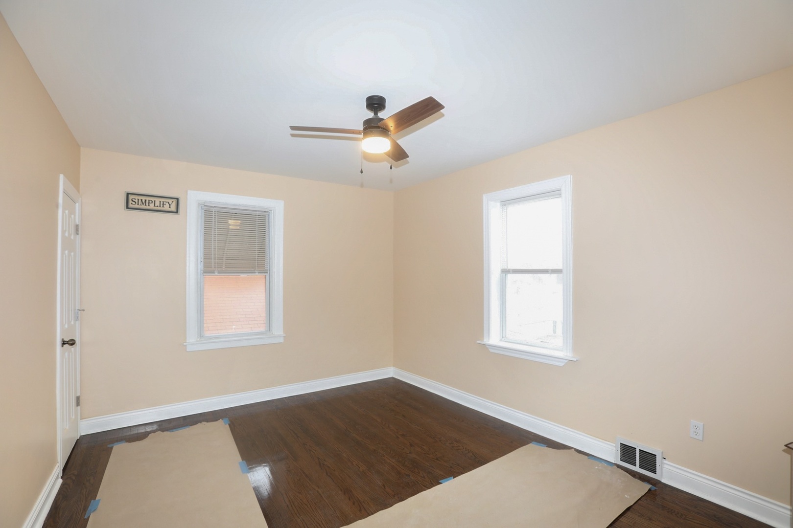 10217 South Prairie Avenue Chicago, IL 60628 - Photo 11 of 23 an empty room with windows and fan