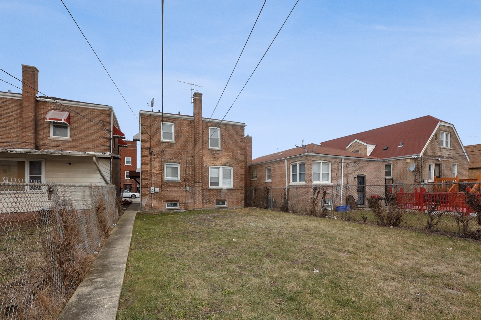 10217 South Prairie Avenue Chicago, IL 60628 - Photo 17 of 23 a view of a big house with a big yard and large trees