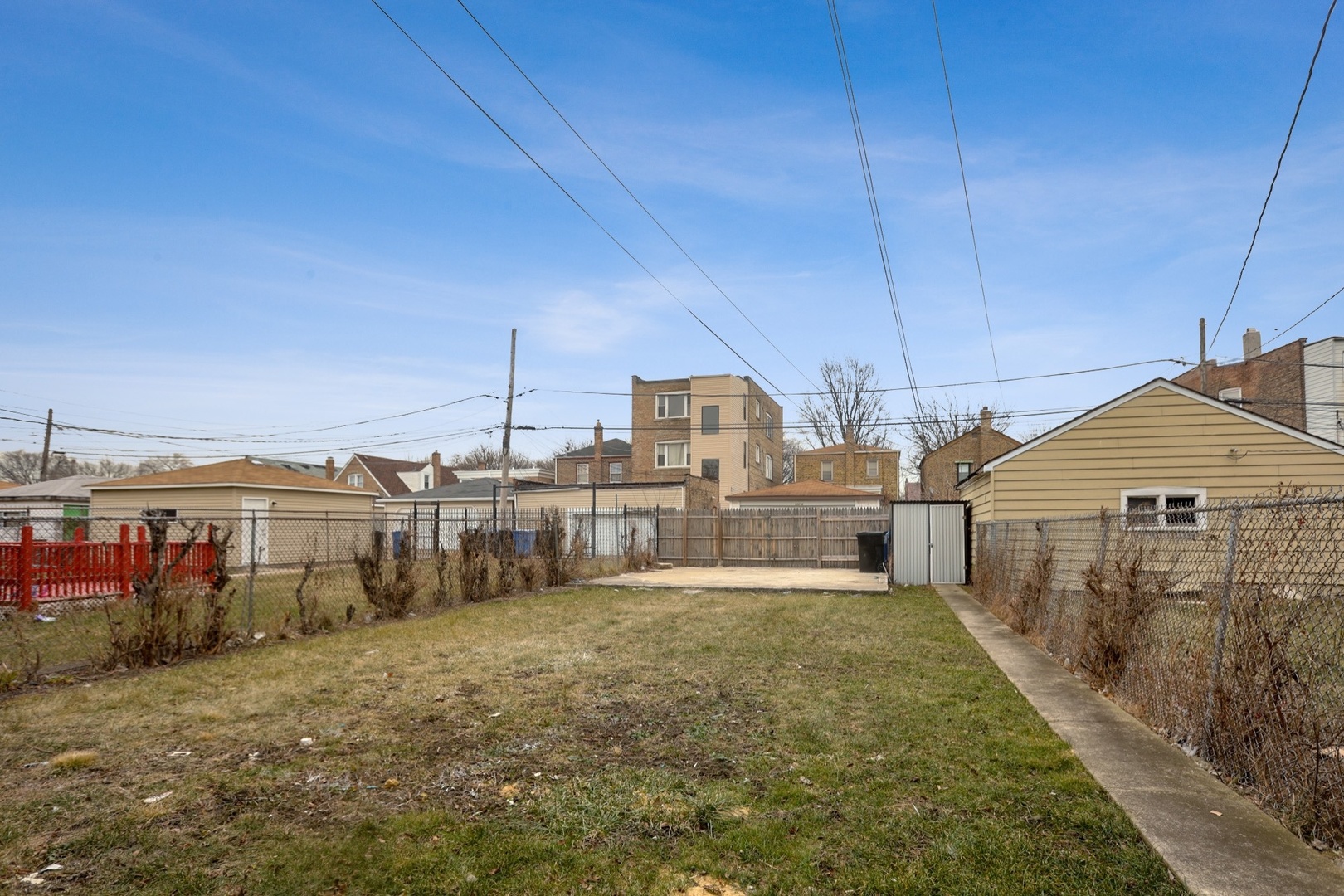 10217 South Prairie Avenue Chicago, IL 60628 - Photo 18 of 23 a view of a house with a yard