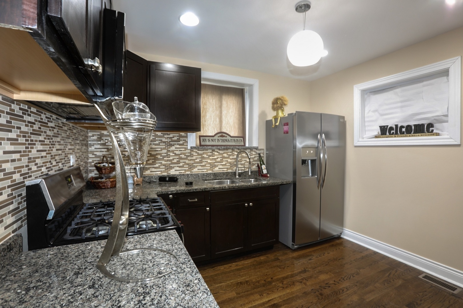 10217 South Prairie Avenue Chicago, IL 60628 - Photo 5 of 23 a kitchen with refrigerator and stove