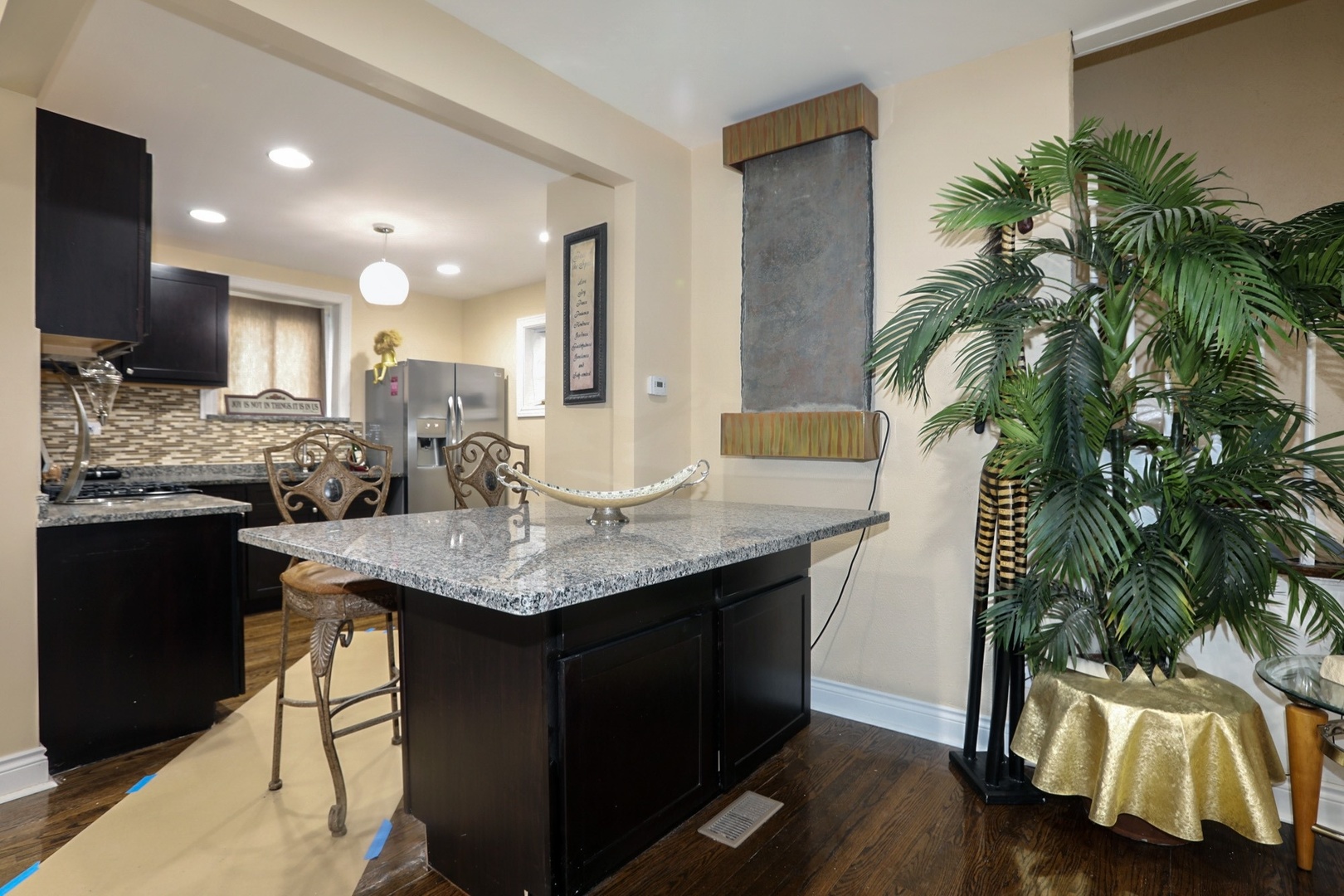 10217 South Prairie Avenue Chicago, IL 60628 - Photo 6 of 23 a kitchen with a sink and a wooden floor