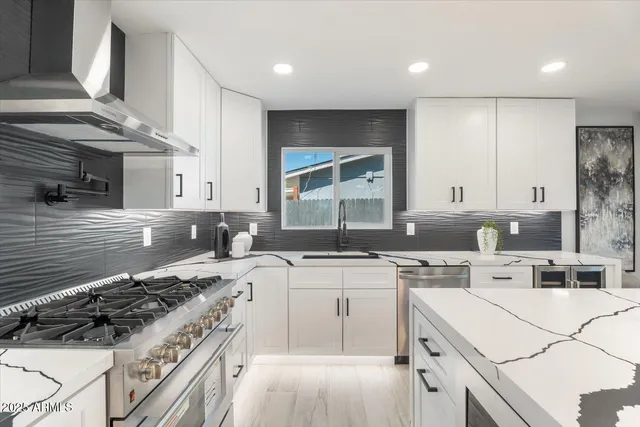 a kitchen with a stove a sink and a refrigerator