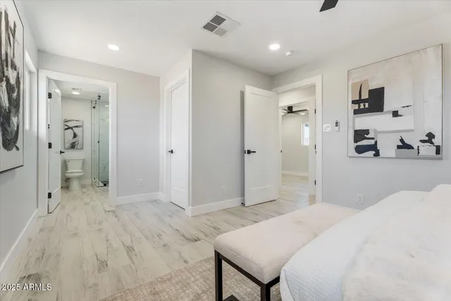 a spacious bedroom with a bed and a view of bathroom
