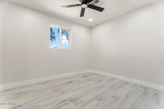 a view of a room with wooden floor and white walls