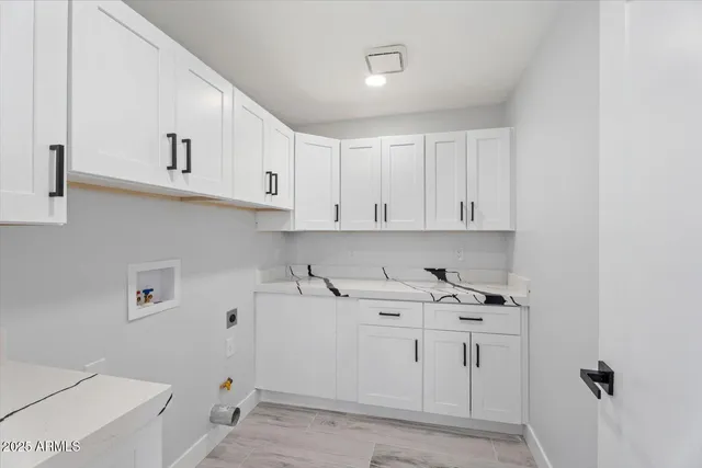 a view of cabinets with sink washer and dryer