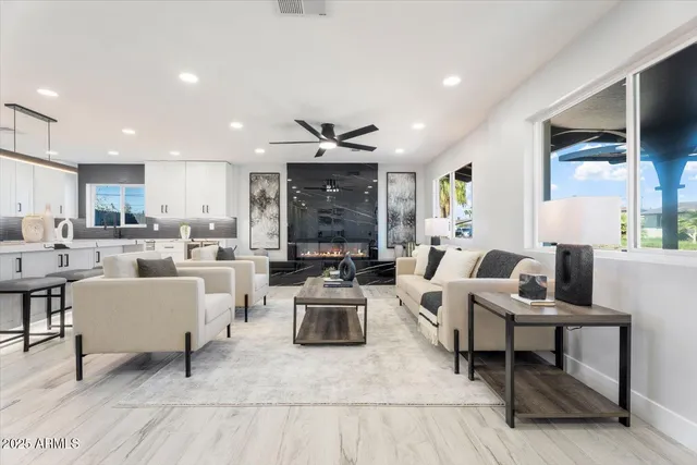 a living room with lots of furniture and view of kitchen