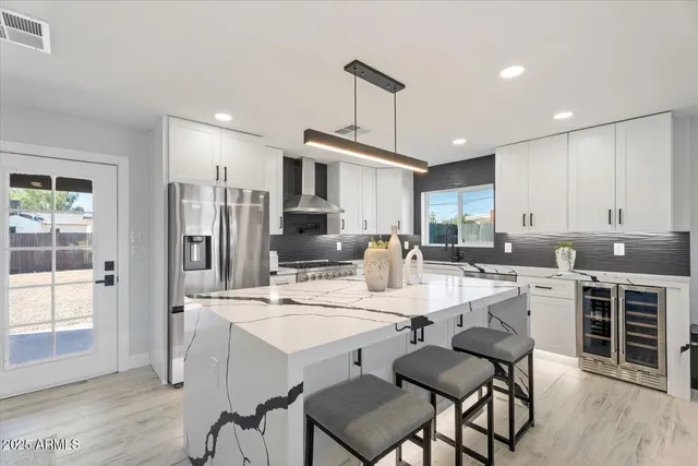 a kitchen with refrigerator cabinets dining table and chairs