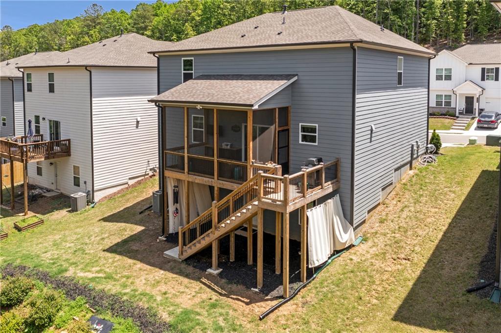 660 Groover Street Ball Ground, GA 30107 - Photo 37 of 53 a view of a house with wooden floor roof and furniture