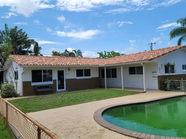 a view of a house with a backyard porch and sitting area