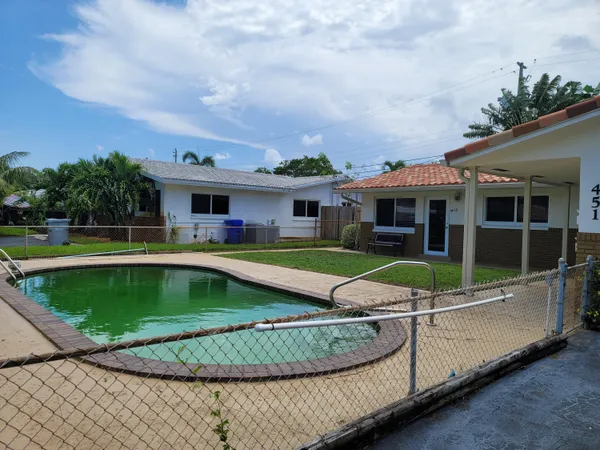 a view of car parked on street next to a road