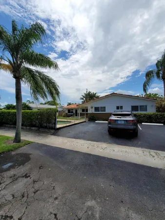 a view of a house with a yard and sitting area