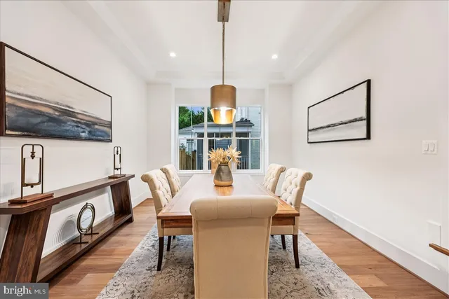 a dining room with furniture a rug and wooden floor