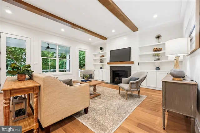 a living room with furniture a large window and a fireplace