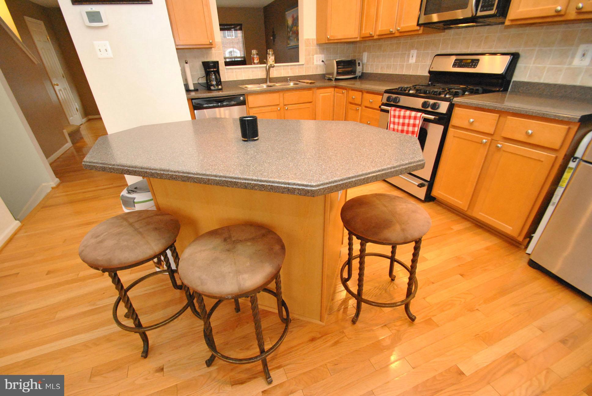 9846 Decatur Road Middle River, MD 21220 - Photo 8 of 26 HUGE EAT IN KITCHEN W/ISLAND & CORIAN COUNTERS