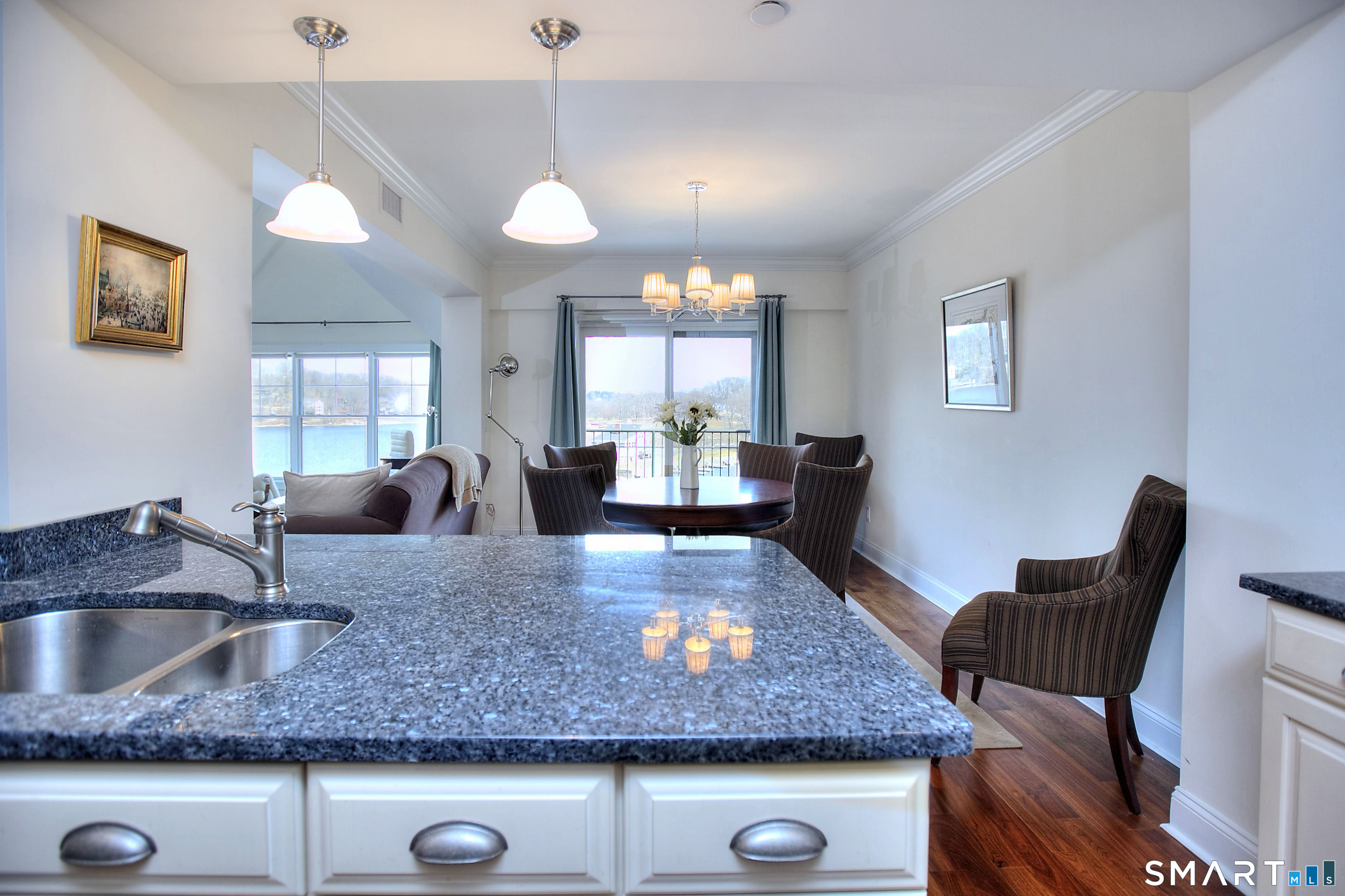 16 Hayestown Road, Unit C402 Danbury, CT 06811 - Photo 14 of 36 a kitchen with kitchen island granite counter tops a dining table and chairs