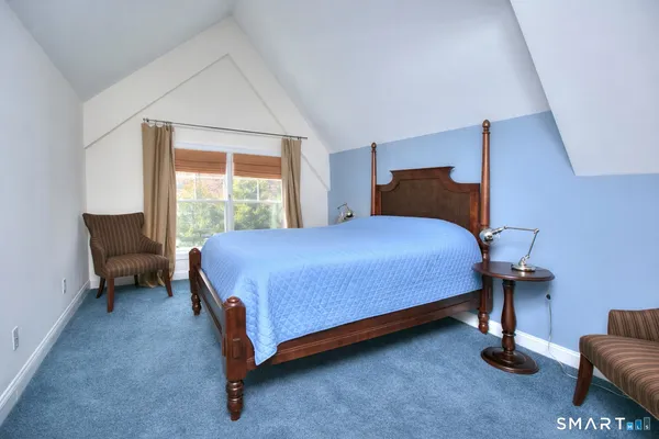 a bedroom with a bed and chair