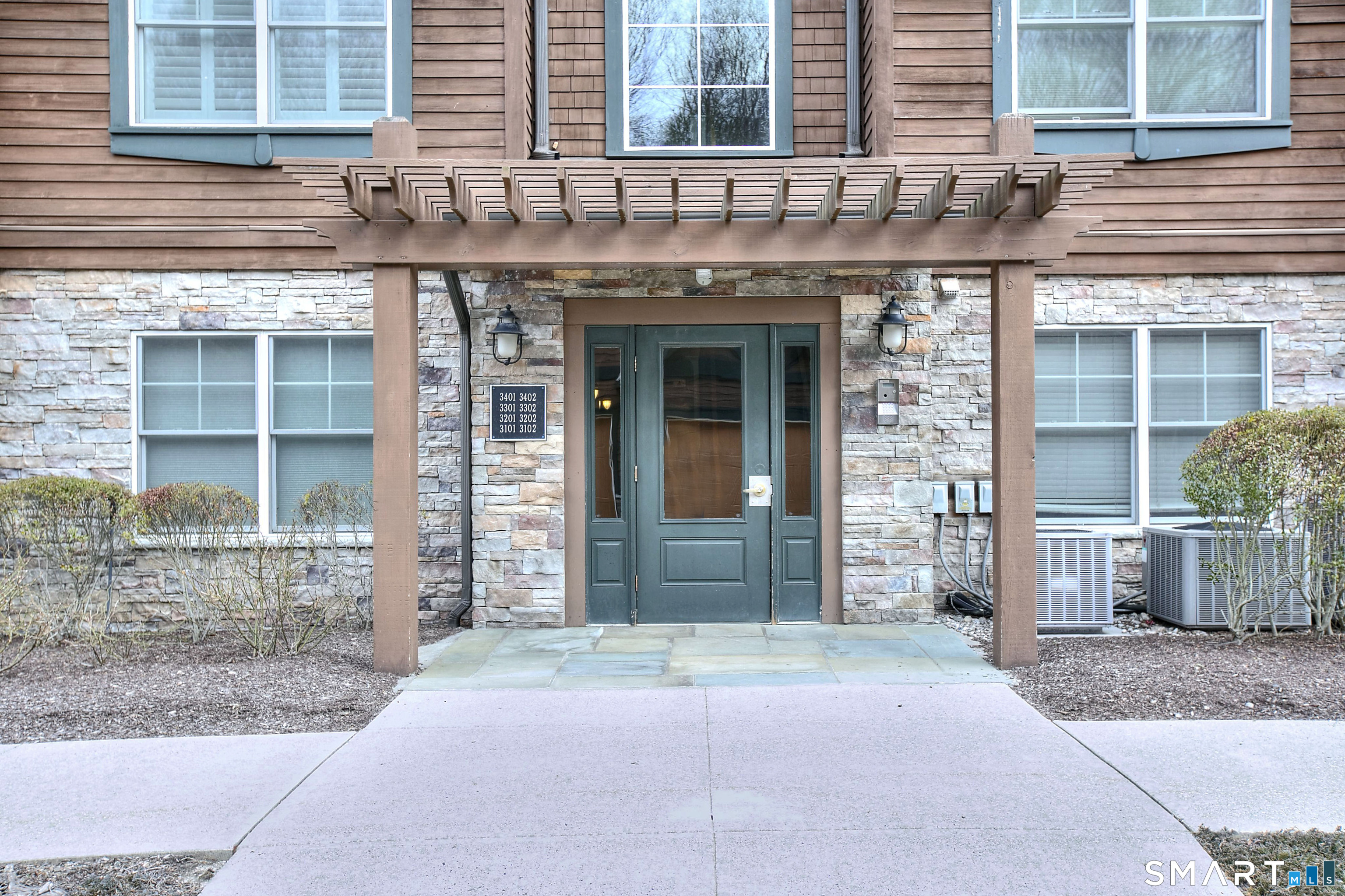 16 Hayestown Road, Unit C402 Danbury, CT 06811 - Photo 3 of 36 a view of a brick building with a outdoor space