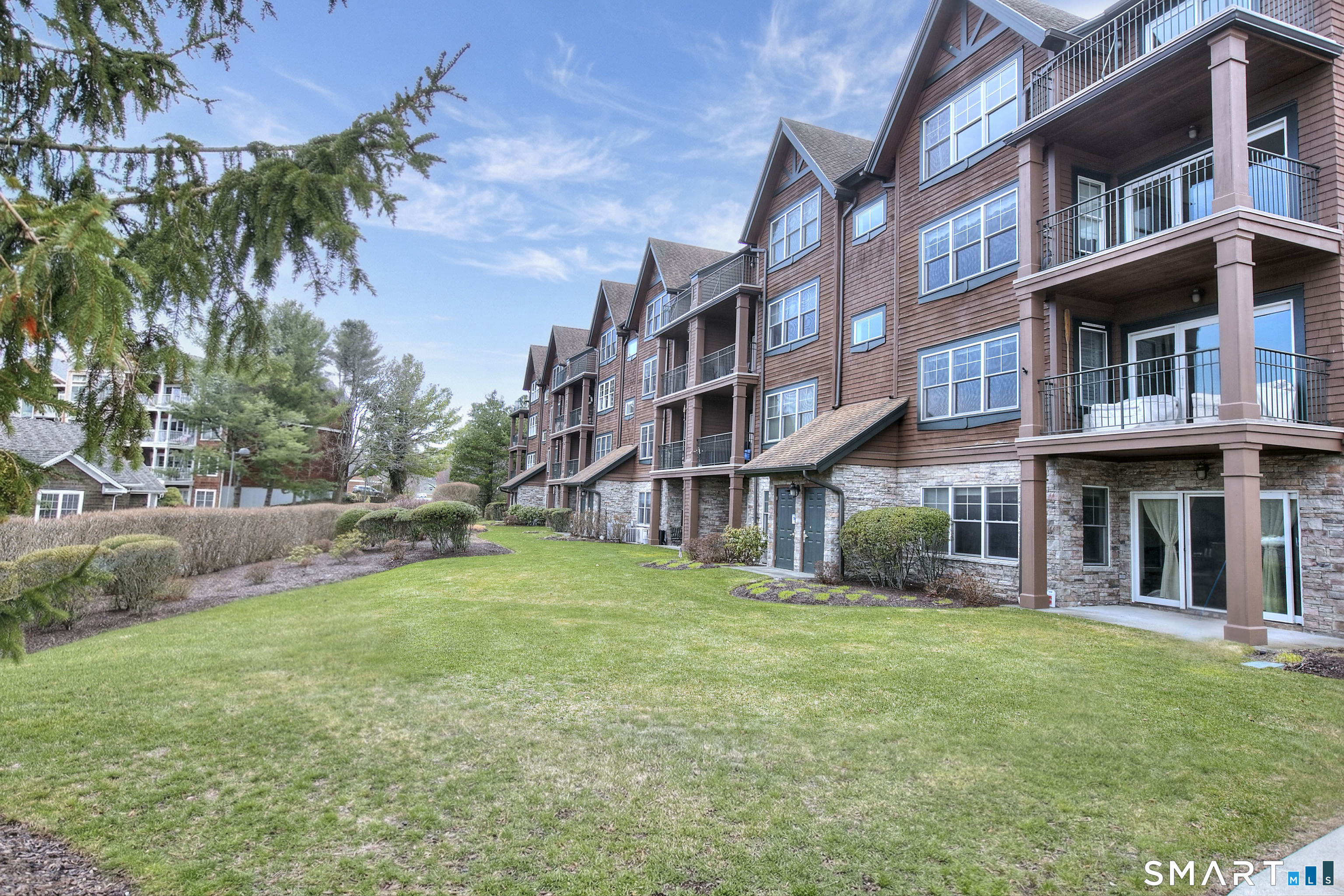 16 Hayestown Road, Unit C402 Danbury, CT 06811 - Photo 32 of 36 a view of a building with a yard