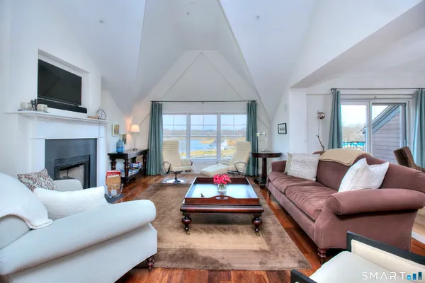 a living room with furniture fireplace and flat screen tv