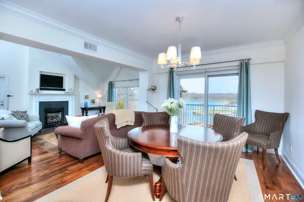 a living room with furniture a fireplace and a chandelier