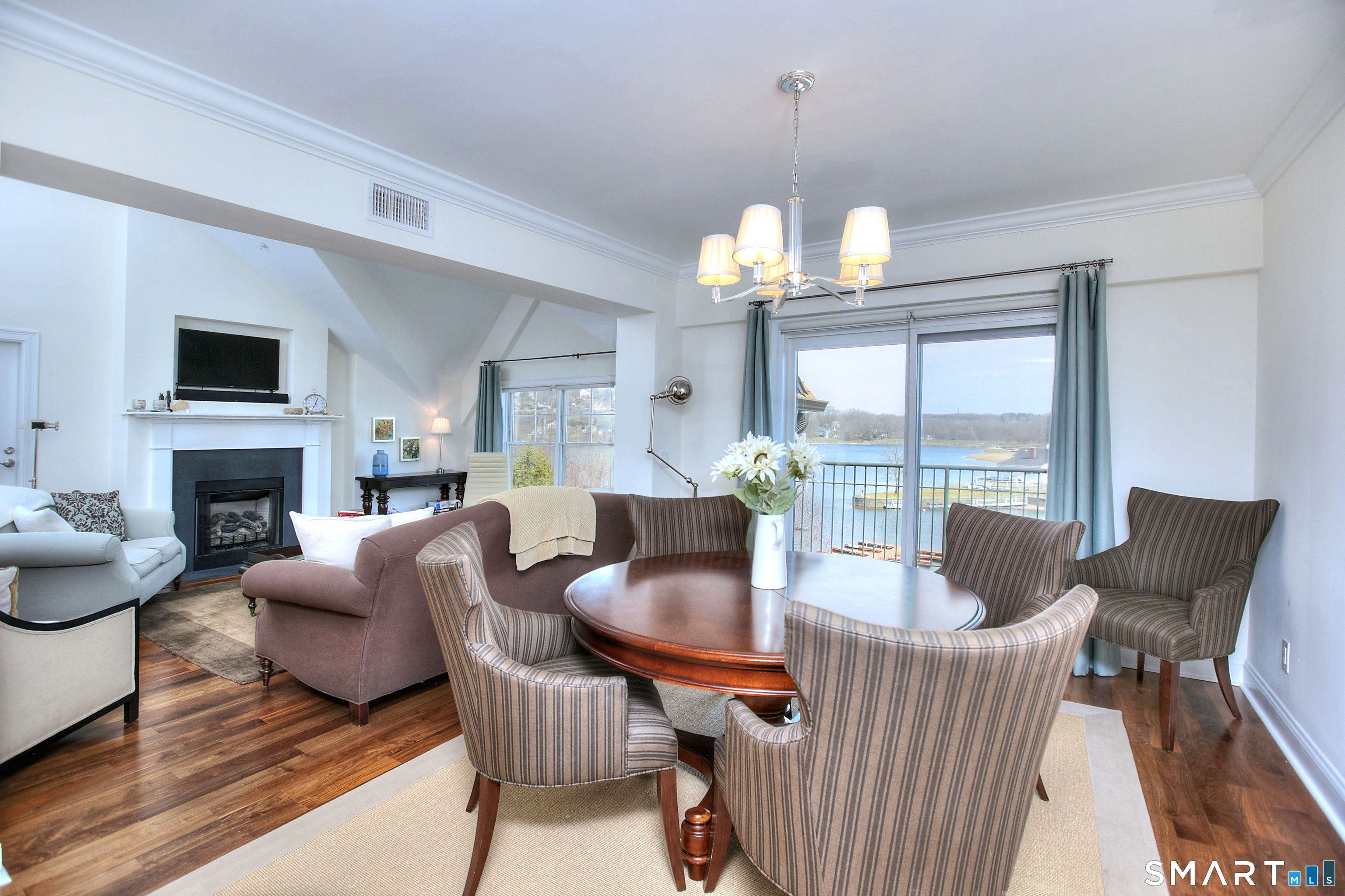 16 Hayestown Road, Unit C402 Danbury, CT 06811 - Photo 10 of 36 a living room with furniture a fireplace and a chandelier