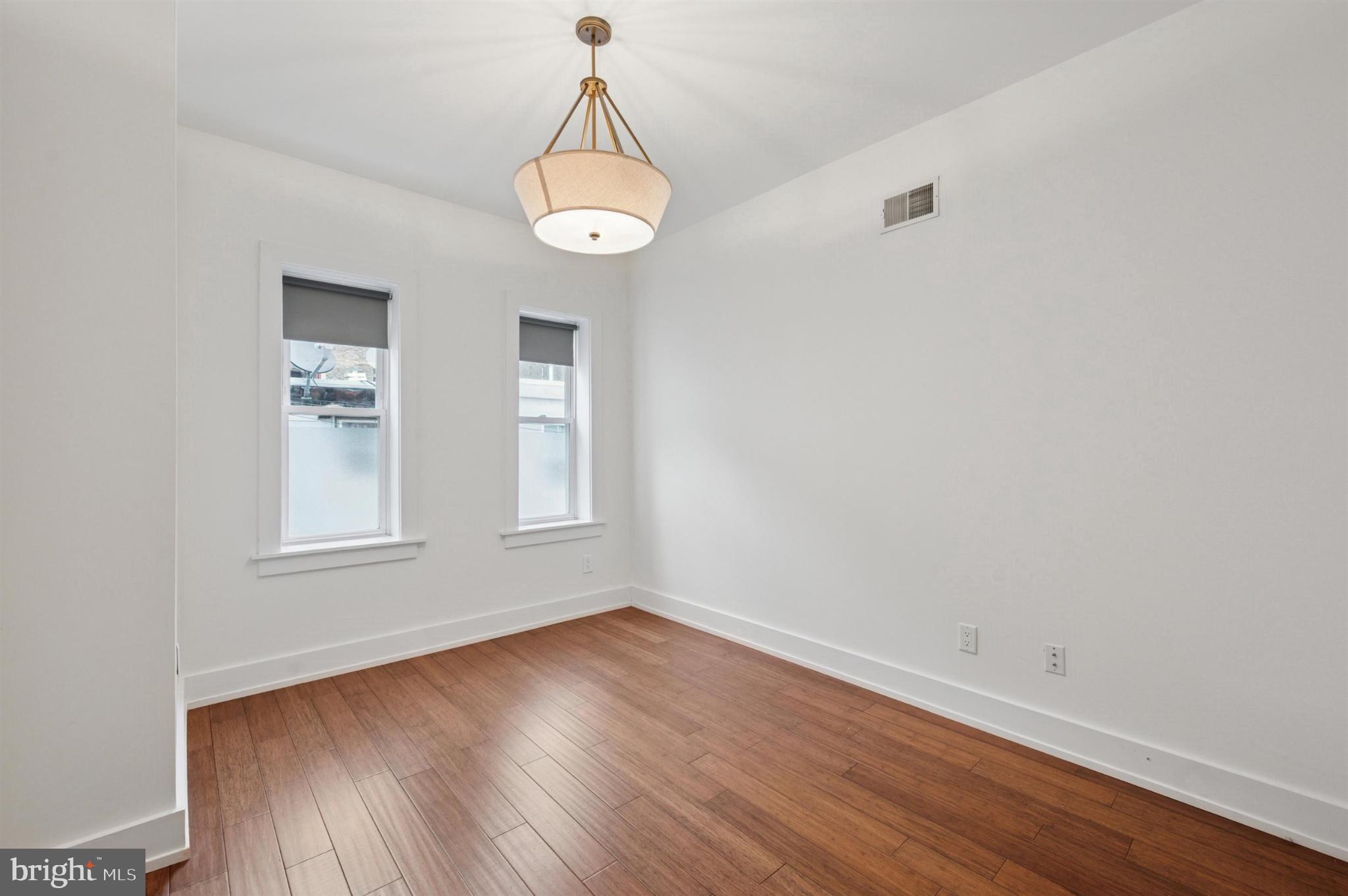 637 Cross Street Philadelphia, PA 19147 - Photo 19 of 28 wooden floor in an empty room with a window