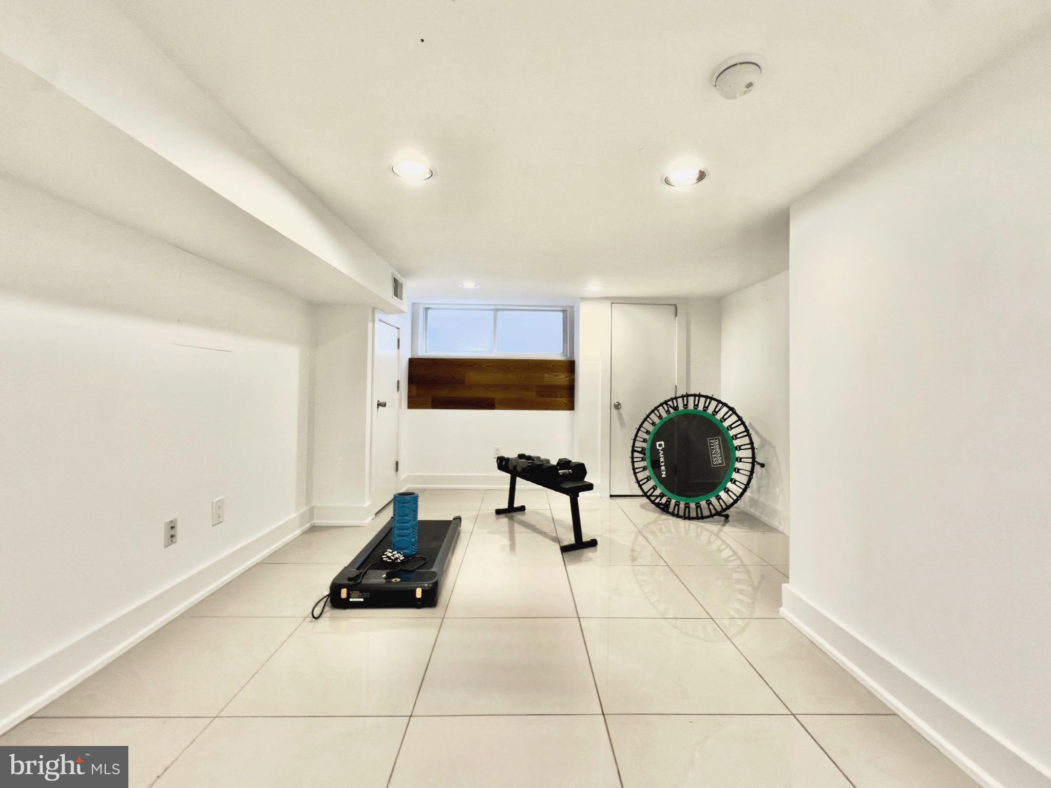 637 Cross Street Philadelphia, PA 19147 - Photo 26 of 28 a living room with furniture a rug and white walls