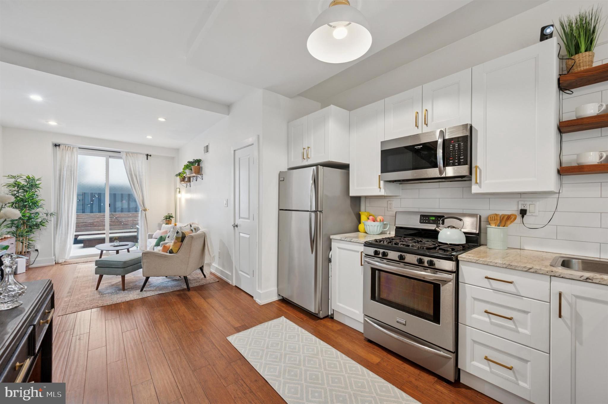 637 Cross Street Philadelphia, PA 19147 - Photo 5 of 28 a kitchen with stainless steel appliances a stove a sink dishwasher a refrigerator microwave and cabinets