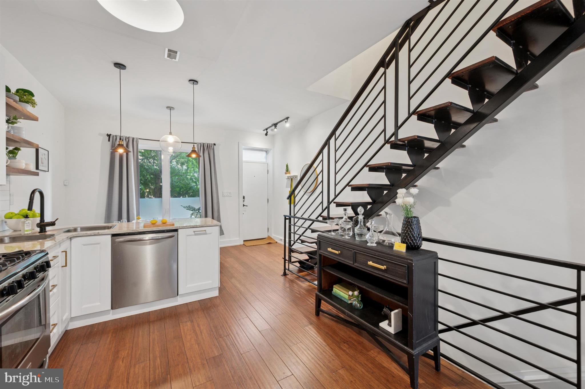 637 Cross Street Philadelphia, PA 19147 - Photo 6 of 28 a kitchen with stainless steel appliances a stove a refrigerator and wooden floor