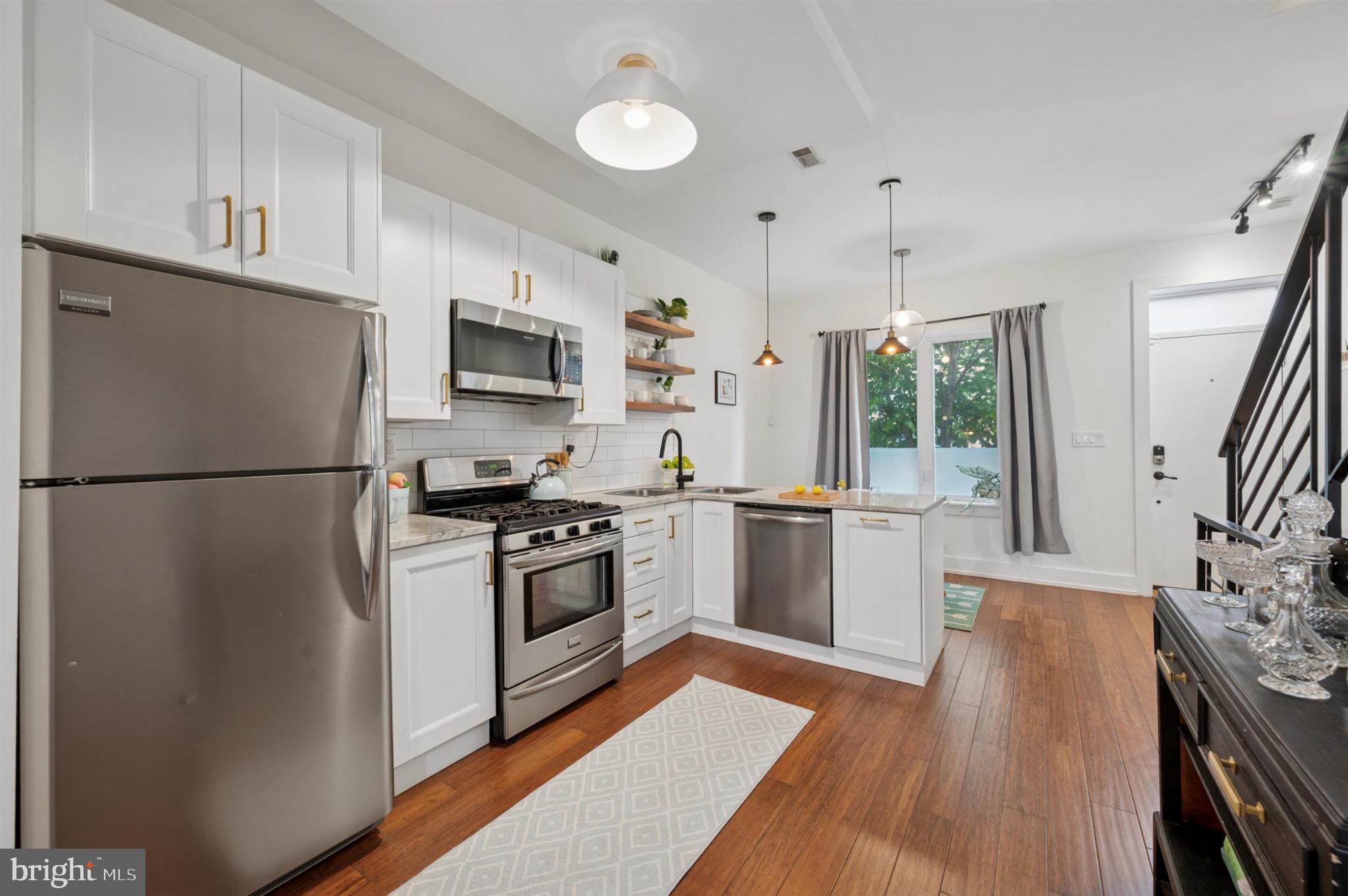 637 Cross Street Philadelphia, PA 19147 - Photo 9 of 28 a kitchen with granite countertop a refrigerator stove top oven and sink