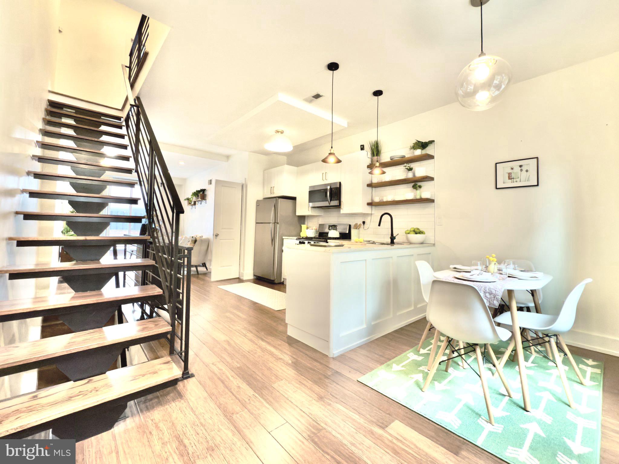 637 Cross Street Philadelphia, PA 19147 - Photo 10 of 28 a living room with couches chairs and kitchen view with wooden floor