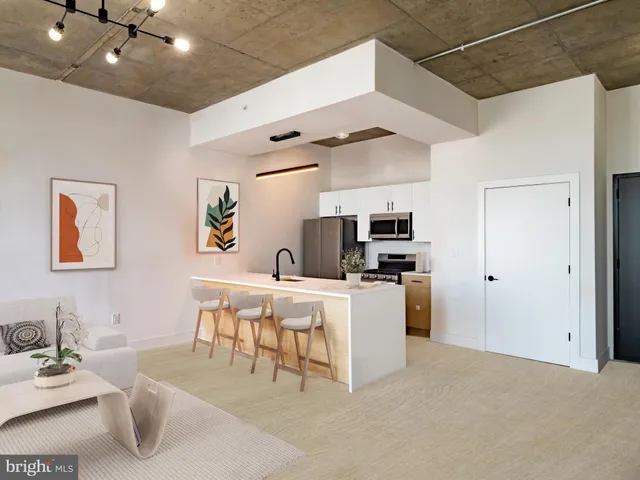 a living room with furniture and kitchen view