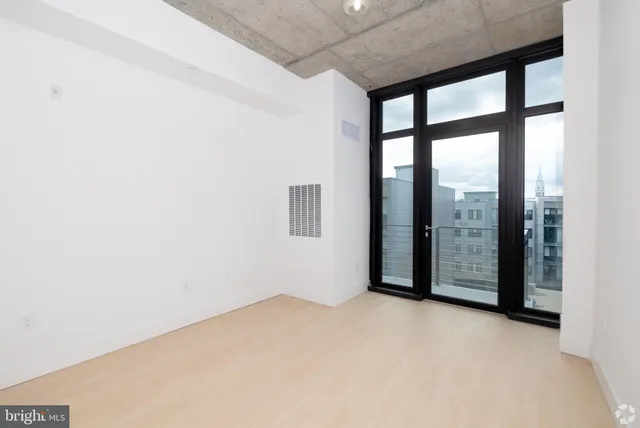 an empty room with sliding glass door