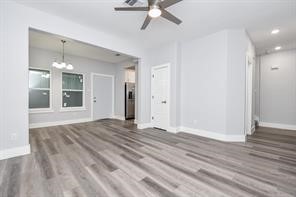 9337 Freeland Street Houston, TX 77075 - Photo 23 of 30 a view of an empty room with wooden floor and a ceiling fan