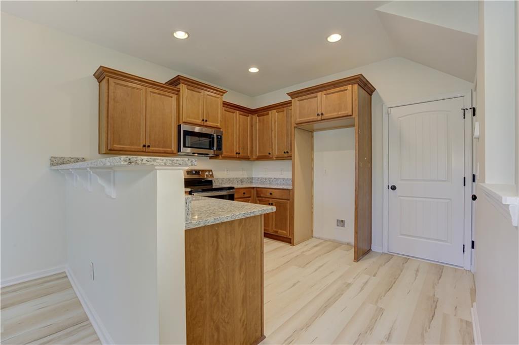 605 Summit Point Canton, GA 30114 - Photo 19 of 56 a kitchen with stainless steel appliances granite countertop a refrigerator stove microwave and sink
