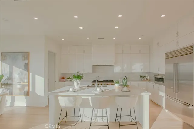 a kitchen with stainless steel appliances kitchen island granite countertop a sink and cabinets