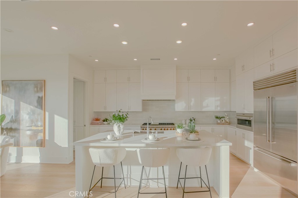 137 Oakstone Irvine, CA 92618 - Photo 13 of 54 a kitchen with stainless steel appliances kitchen island granite countertop a sink and cabinets