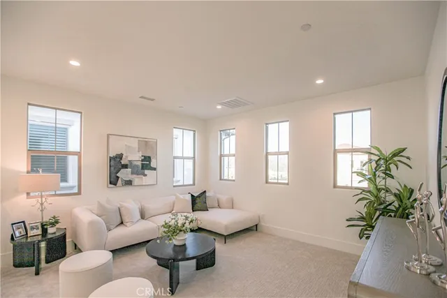 a living room with furniture flowerpot and a window