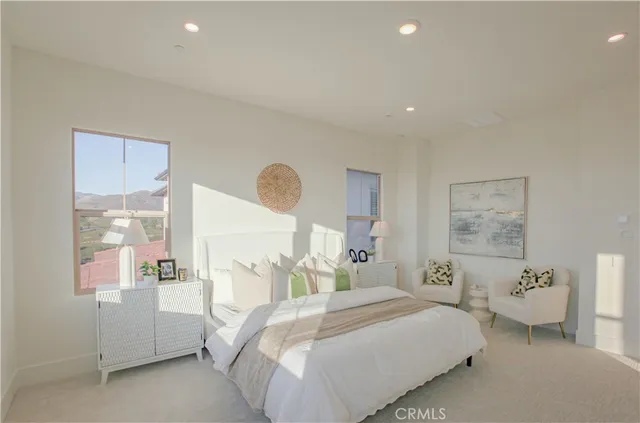 a spacious bedroom with a bed and a couch