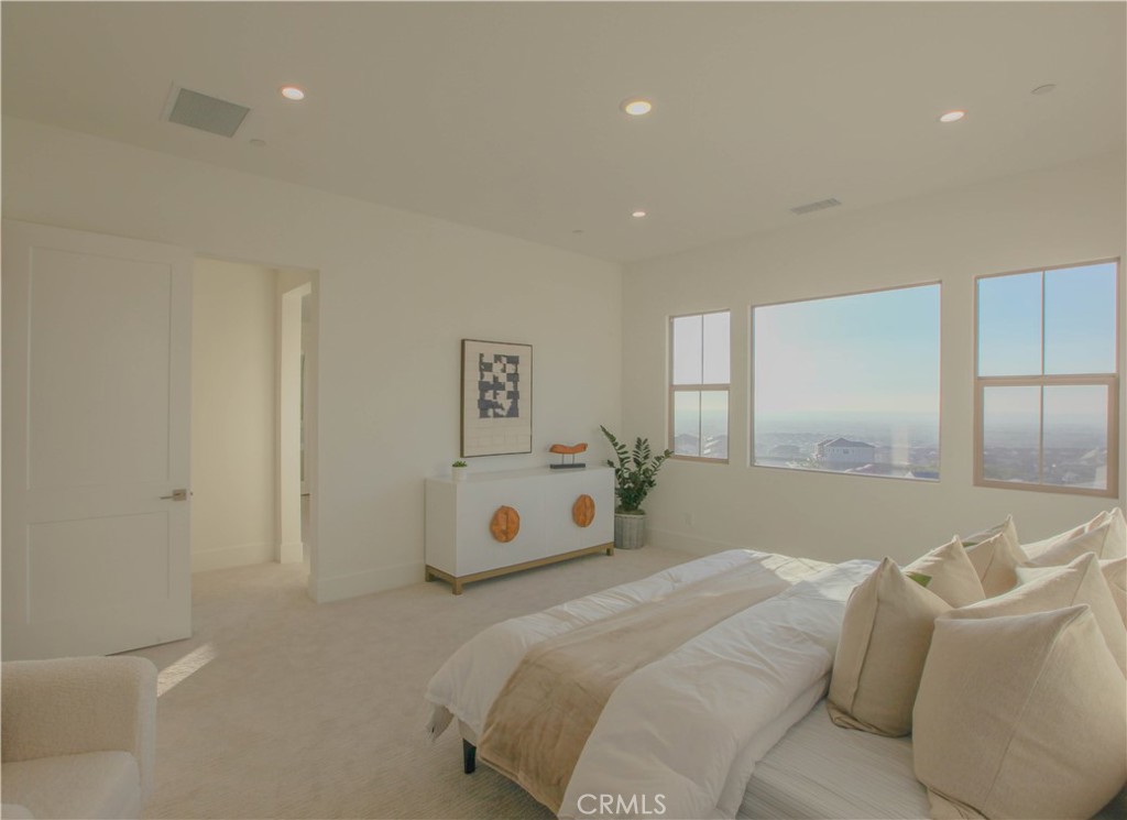 137 Oakstone Irvine, CA 92618 - Photo 31 of 54 a spacious bedroom with a bed and a couch