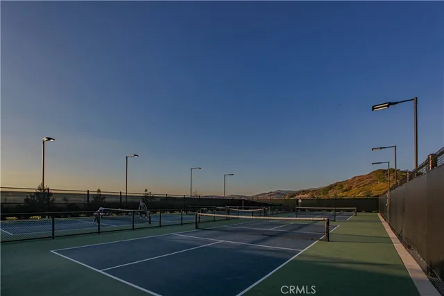 a view of swimming pool with outdoor seating and a lake view
