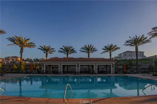 a view of a swimming pool with a patio and a yard