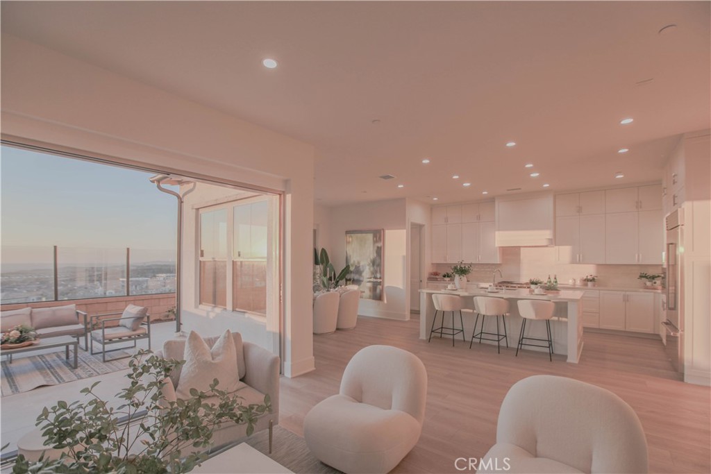 137 Oakstone Irvine, CA 92618 - Photo 49 of 54 a living room with lots of furniture and view of kitchen