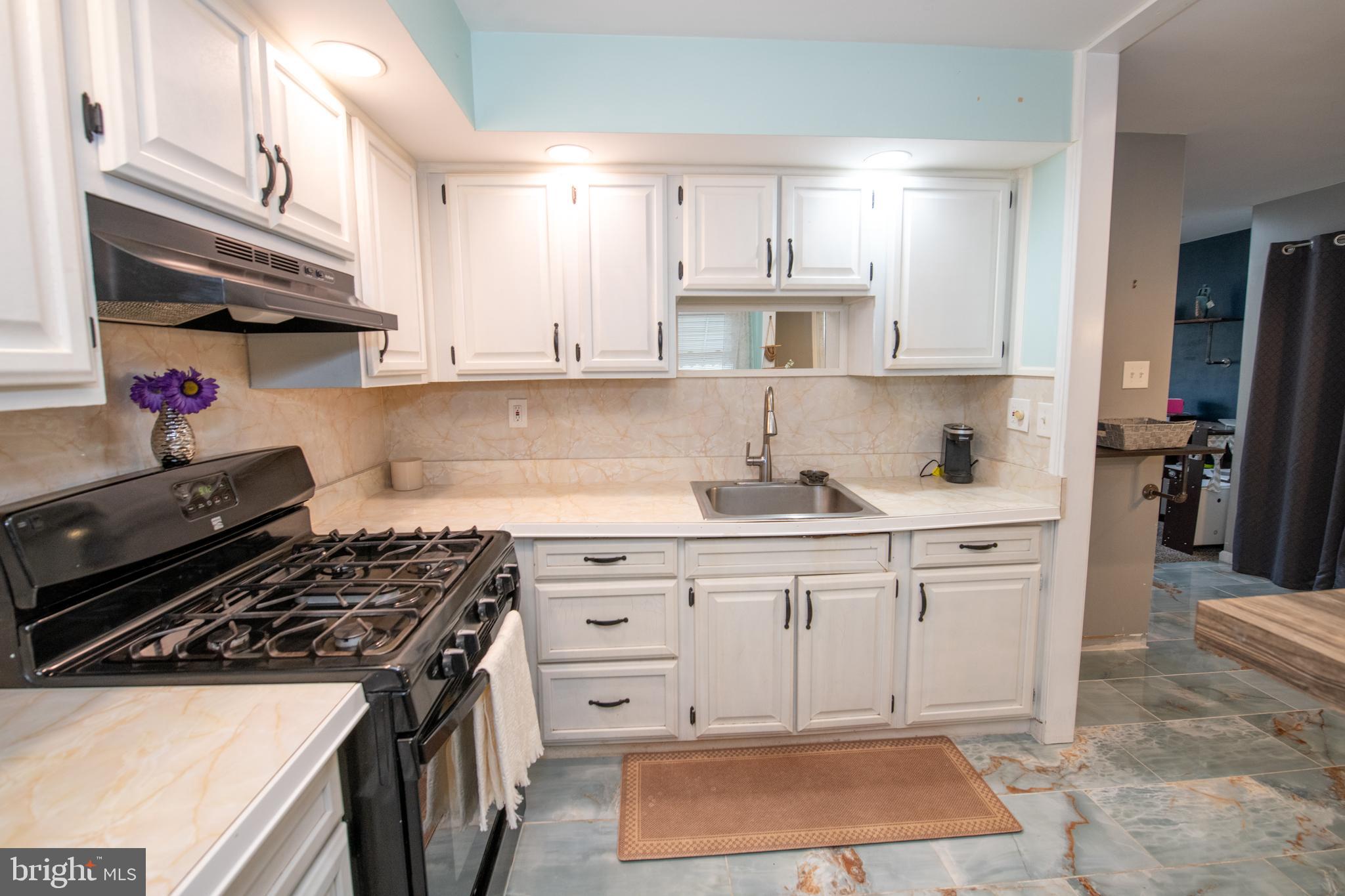 12506 Chilton Road Philadelphia, PA 19154 - Photo 14 of 55 a kitchen with granite countertop a stove and a sink