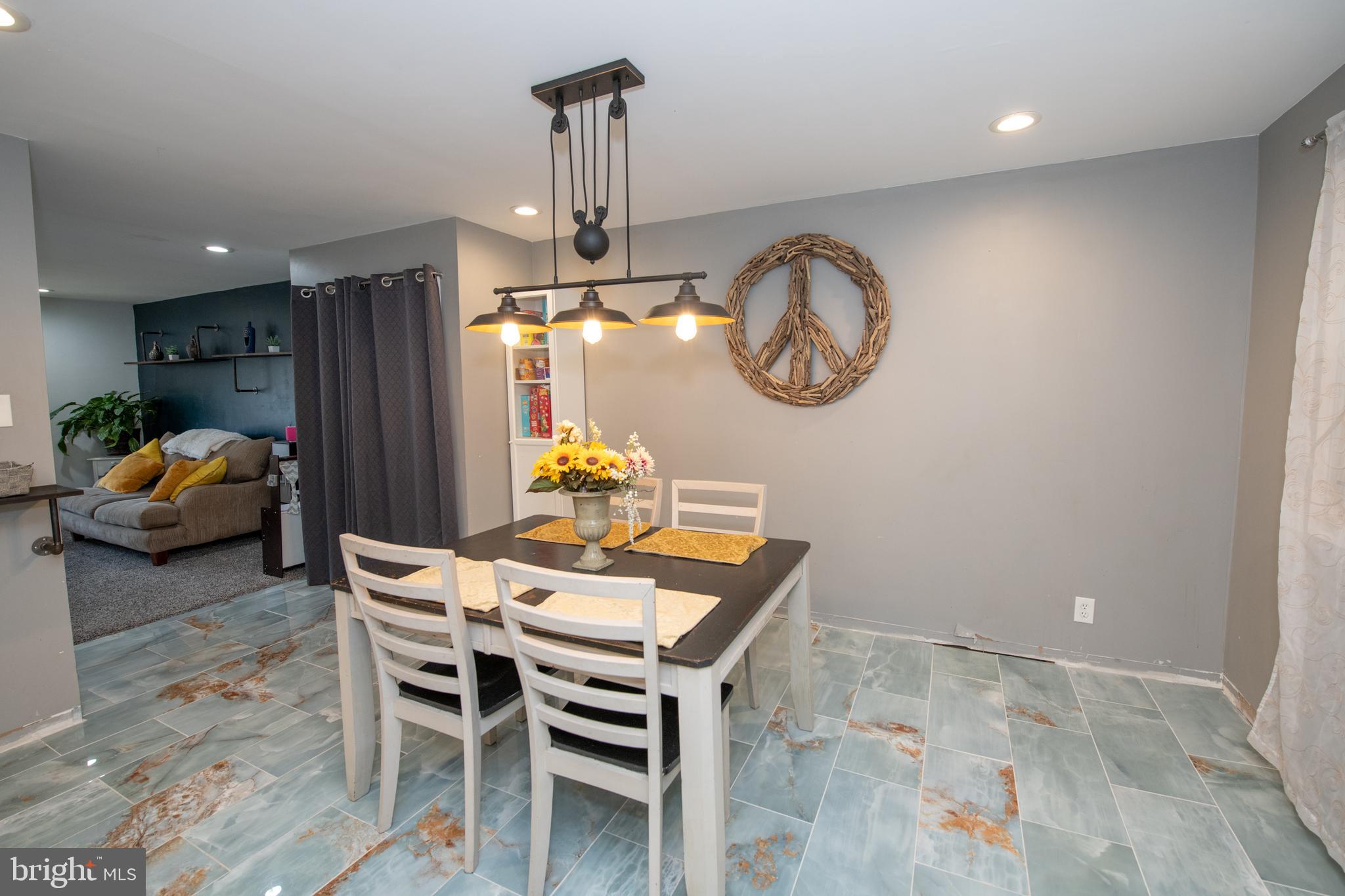 12506 Chilton Road Philadelphia, PA 19154 - Photo 19 of 55 a view of a dining room with furniture chandelier and kitchen view